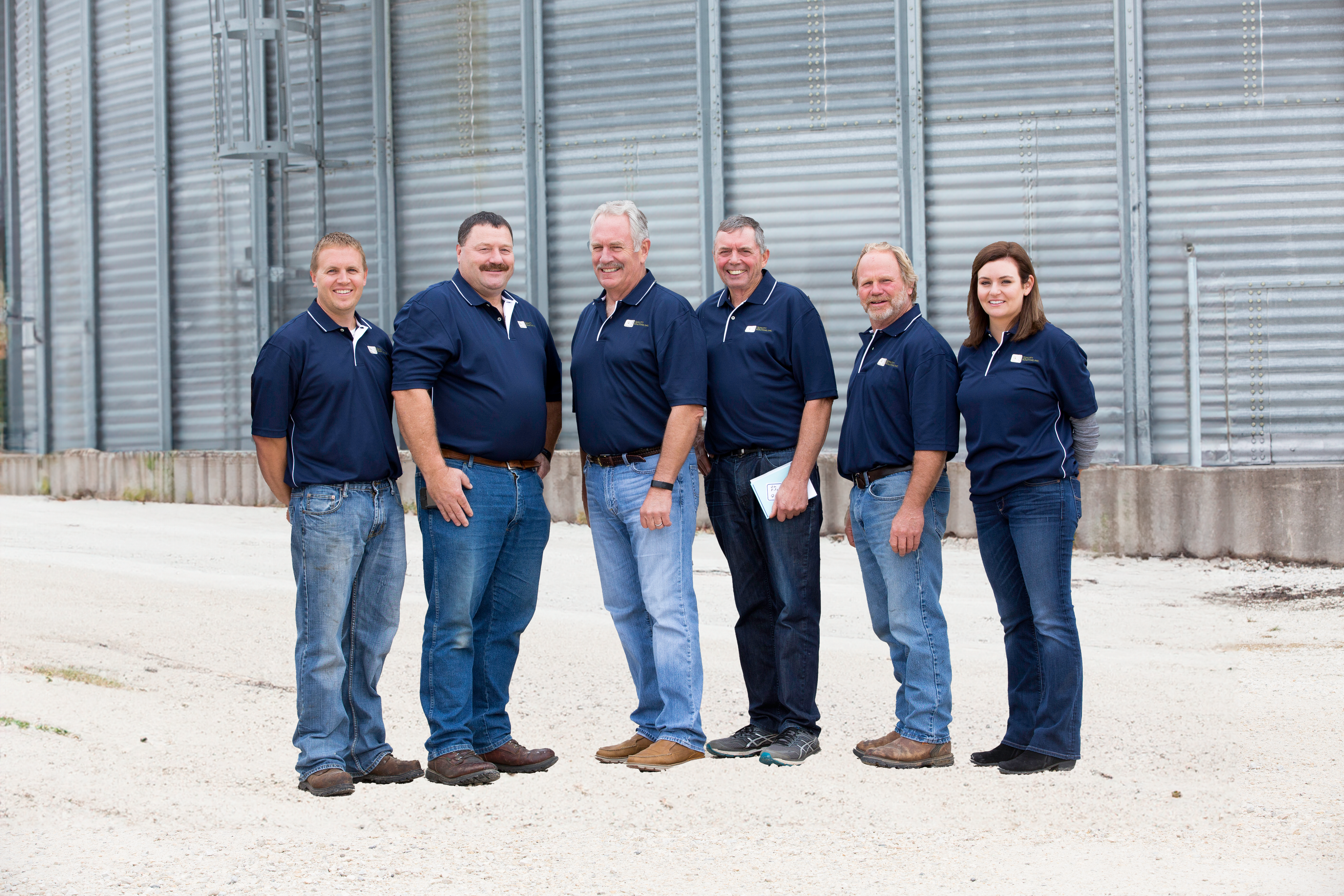 Team of Owners and Management standing next to our facility